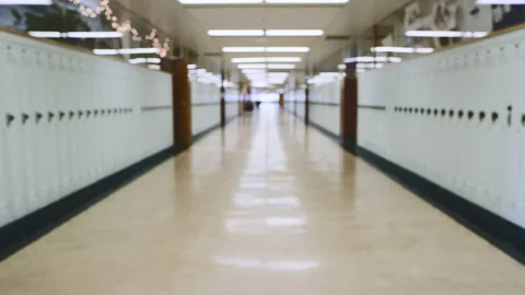 High school hallway lined with lockers, capturing an empty atmosphere Stock Footage 310212857