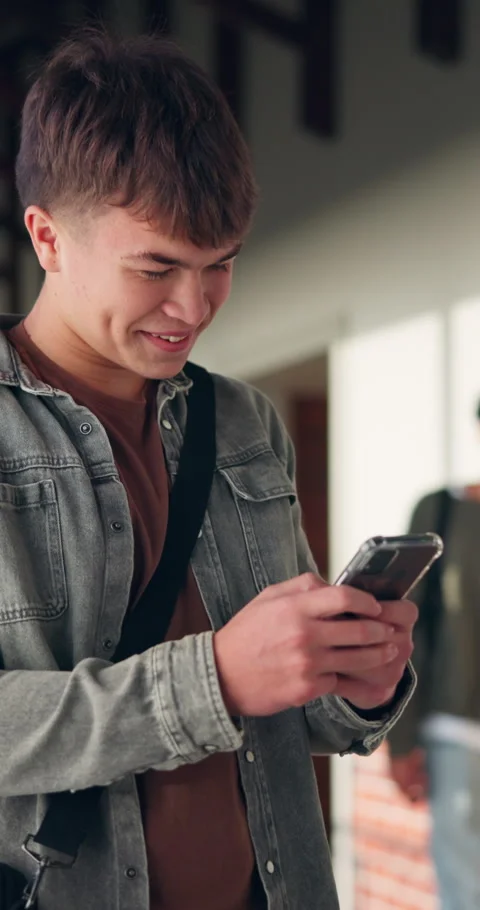 High school, laugh and boy with phone typing for social media, online chat and Stock Footage 340946672