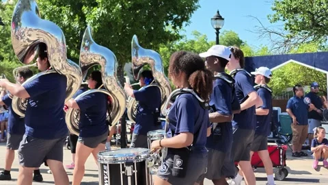 High school marching band performing in street parade 動画素材 340941860