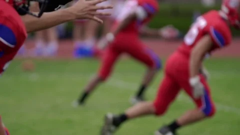 High school quarterback receives snap, in slow motion Video stock 84323825