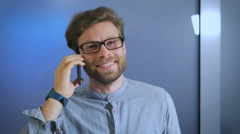 High school student is in college corridor and smiling talking on smartphone Stock Footage 68617859