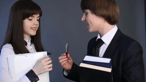 High school student Couple in uniform talking with each other. Closeup portrait 스톡 동영상 74261297