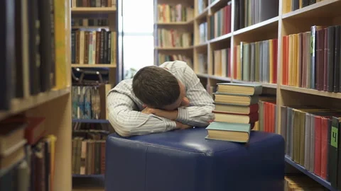 A high school student fell asleep in the library over books. Stock Footage 124530696