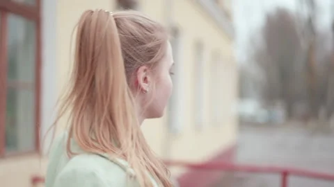 High school student leaves school door and stops on the threshold. Close-up. Stock Footage 145789141