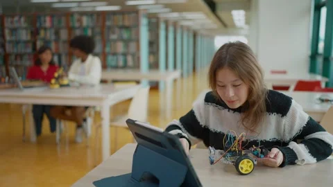 High school student presenting their car model robot via video call on a tablet. Stock Footage 320400671