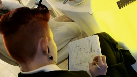 High school student solving homework at a family event Stock Footage 261509244