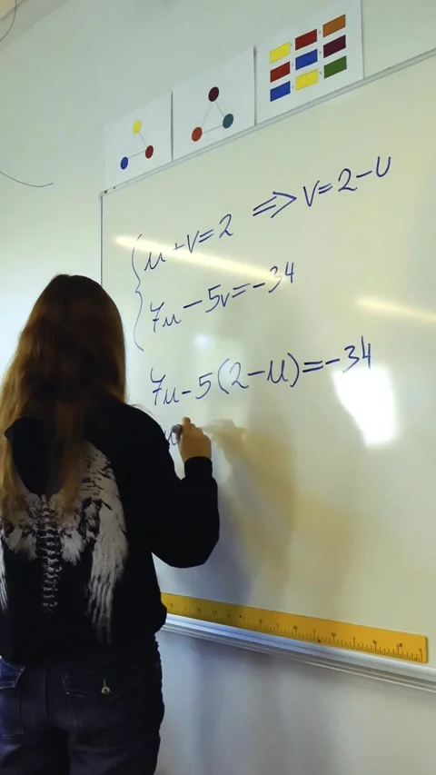 High school student solving math equations on a classroom whiteboard Stock Footage 347064711