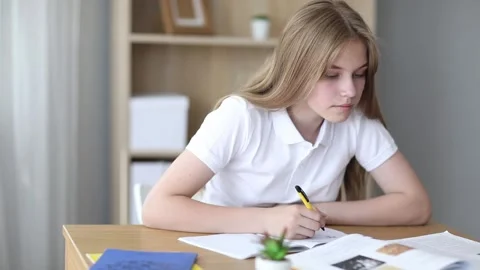 A high school student takes notes from a book, a teenage girl does her homework 스톡 동영상 158229437