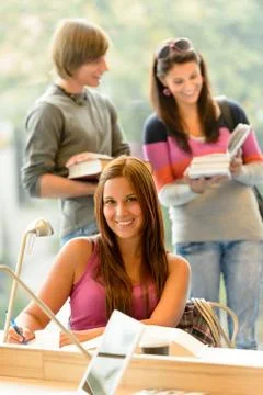 High-school student taking notes in library study Stock Photos