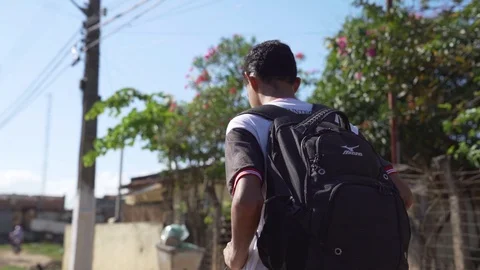High School Student Walking Along Hallway in slowmotion Stock Footage 126046676