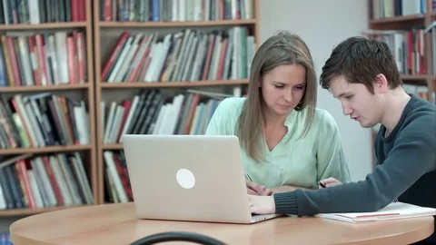 High school student working in library after classes, using laptop 스톡 동영상 77507942