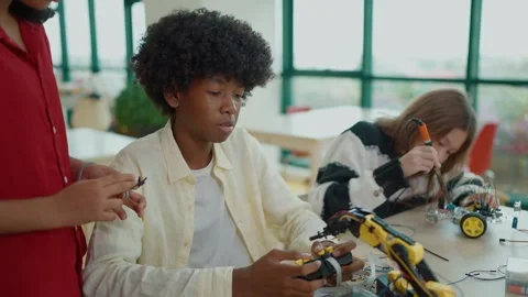 High school students build and programming electric robots project at classroom. Stock Footage 320040736