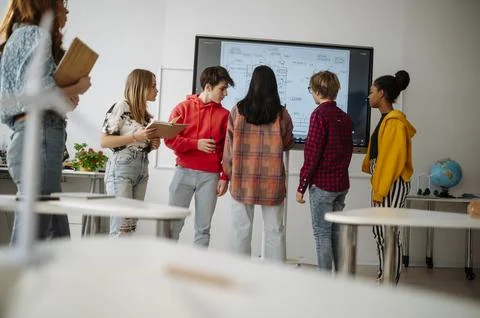High school students collaborating on engineering project using interactive Stock Photos