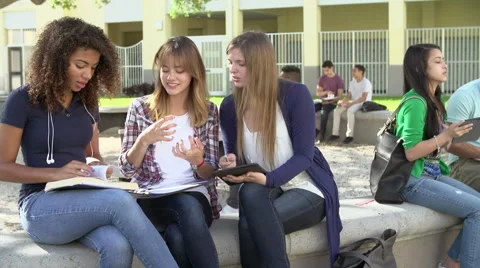 High School Students Collaborating On Project In Playground Stock Footage