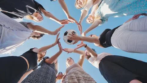 High school students demonstrating teamwork and sportsmanship by forming a Stock Photos
