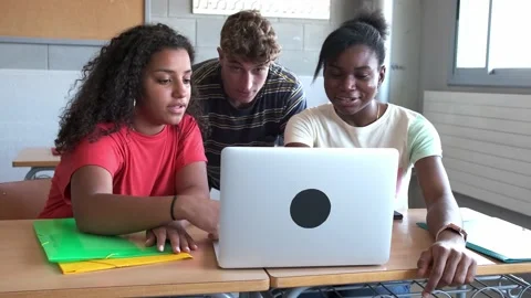 High school students doing homework together using laptop. 4k handheld video. Stock Footage 220697172