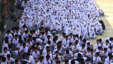 High school students gather in their schoolyard before class. Stock Footage 343827228