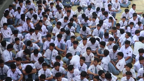 High school students gather in their schoolyard before class. Stock Footage 343829083