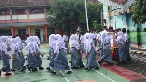 High school students in Java, Indonesia, participate in a charity Stock Footage 323240204