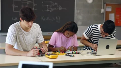 High school students learning to build electronic circuits at high school Stock Footage 242438905