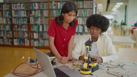 High school students learning, build electronic robot model together for project Stock Footage 320400068