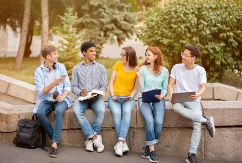 High-School Students Learning Doing Homework Together Sitting Outside Stock Photos