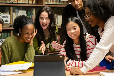 High school students learning together watching digital tablet Stock Photos