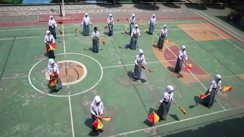 High school students practice semaphore in the schoolyard. Stock Footage 344697176