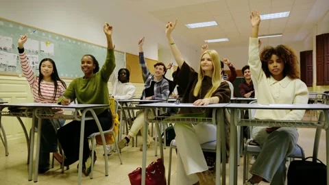 High school students raising hands in class Stock Footage 343274320