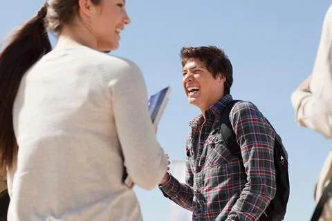 High school students talking and laughing outside Foto stock