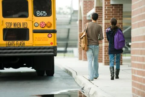 High school students walking toward school bus Stock Photos