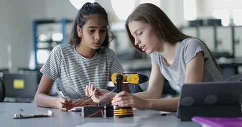 High school students working on a robotic arm in class Stock Footage