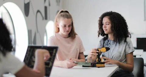 High school students working on a robotic arm in class Stock Footage 116659570