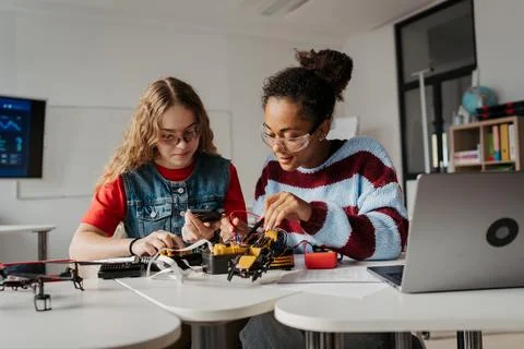 High school students working on robotics project. Girls in STEM. Stock Photos