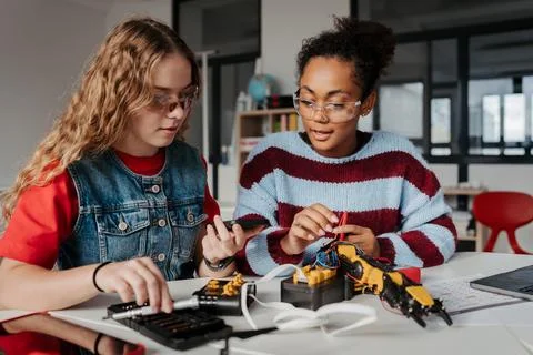 High school students working on robotics project, using online AI app to answer Stock Photos