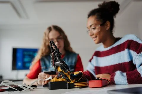 High school students working on robotics project, using online AI app to answer Stock Photos