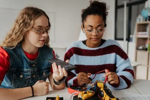 High school students working on robotics project, using online AI app to answer Stock Photos