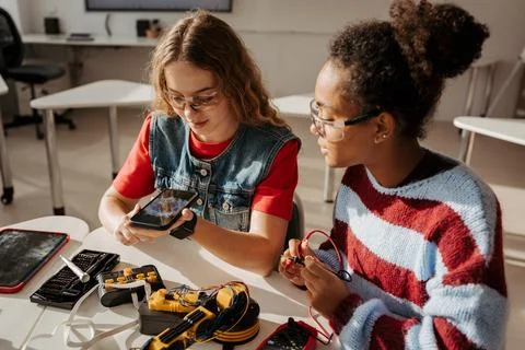 High school students working on robotics project, using online AI app to answer Stock Photos