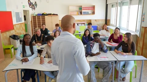 High school teacher interacting with diverse classroom students Stock Footage 345051805