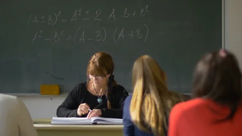 High school teacher is writing a test for students Stock Footage 114065210