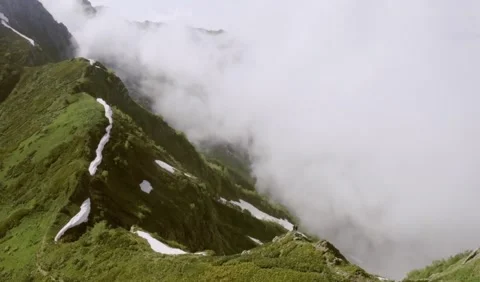 A high shot from the cloudy sky on a high green mountain taken 4K Stockbeeldmateriaal 143809997
