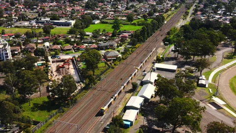 High shot of Train parked on rail track in Australia with suburbs Video stock 223092111