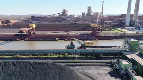 High side view across coal yard and harbor cranes Stock Footage 331205732