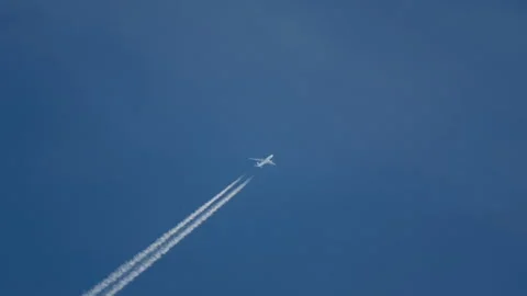 High in the sky an airplane and a trail Stock Footage