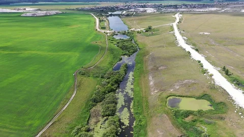 High in the sky flying over a beautiful river, summer and blue sky Stock Footage 128304477