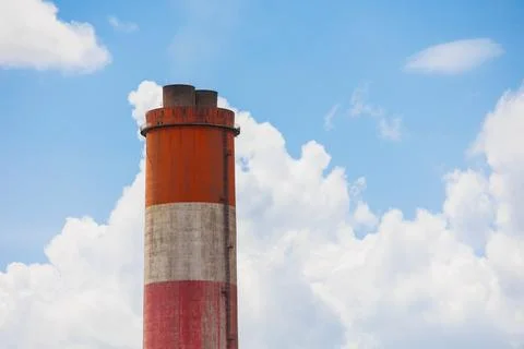 High smoke stack chimney low carbon emission against blue sky, Green Indust.. Fotos de archivo