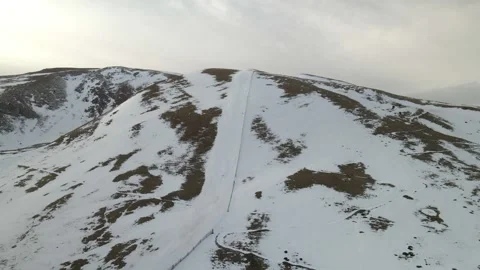 A high snow-capped mountain with a ski slope. aerial view Stock Footage 287008107