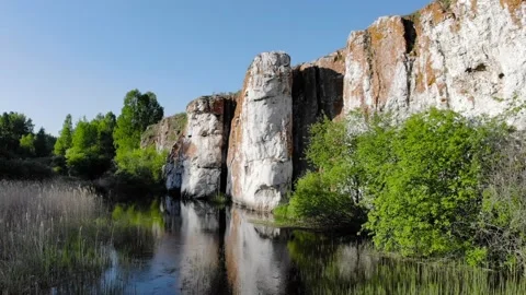 High snow-white limestone cliffs on the banks of the river. Aerial photography Stock Footage 131621075