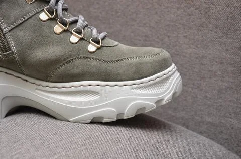 High-soled boots on a gray background.  Stock Photos