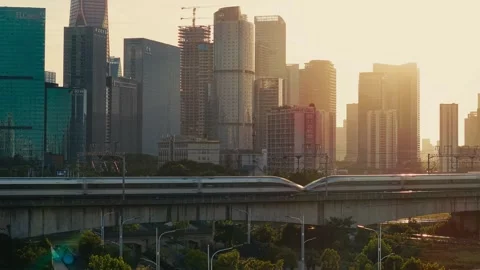 High speed bullet train moves across the city landscape of Hangzhou during the Stock Footage 340939801